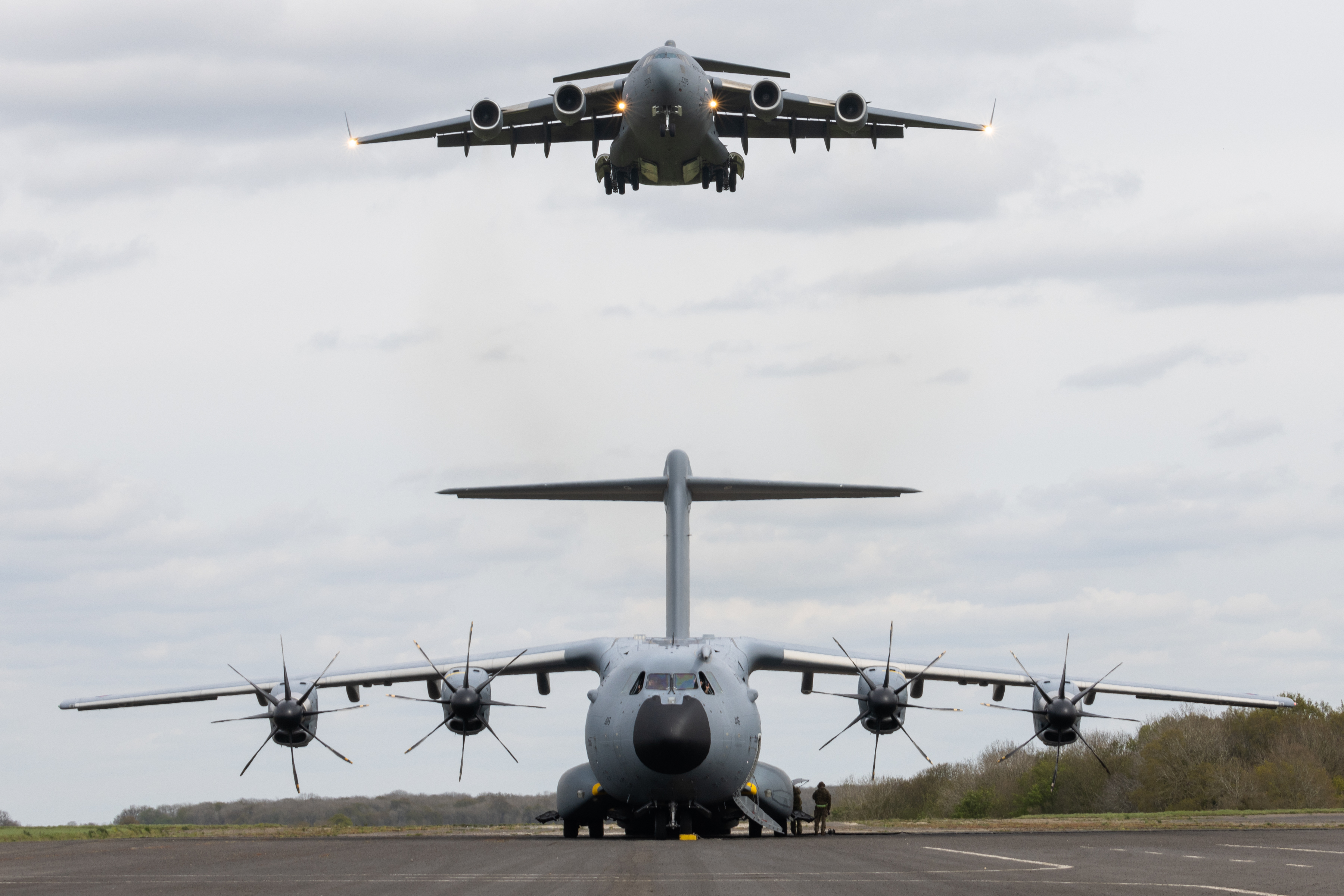 RAF Globemaster performing a low pass over an Atlas C Mk.1 aircraft.
